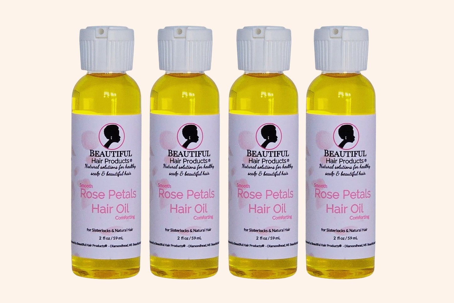 Four bottles of Rose Petals Scalp & Hair Oil bottle, 2oz with pink and cream label featuring rose petals for scalp and hair nourishment