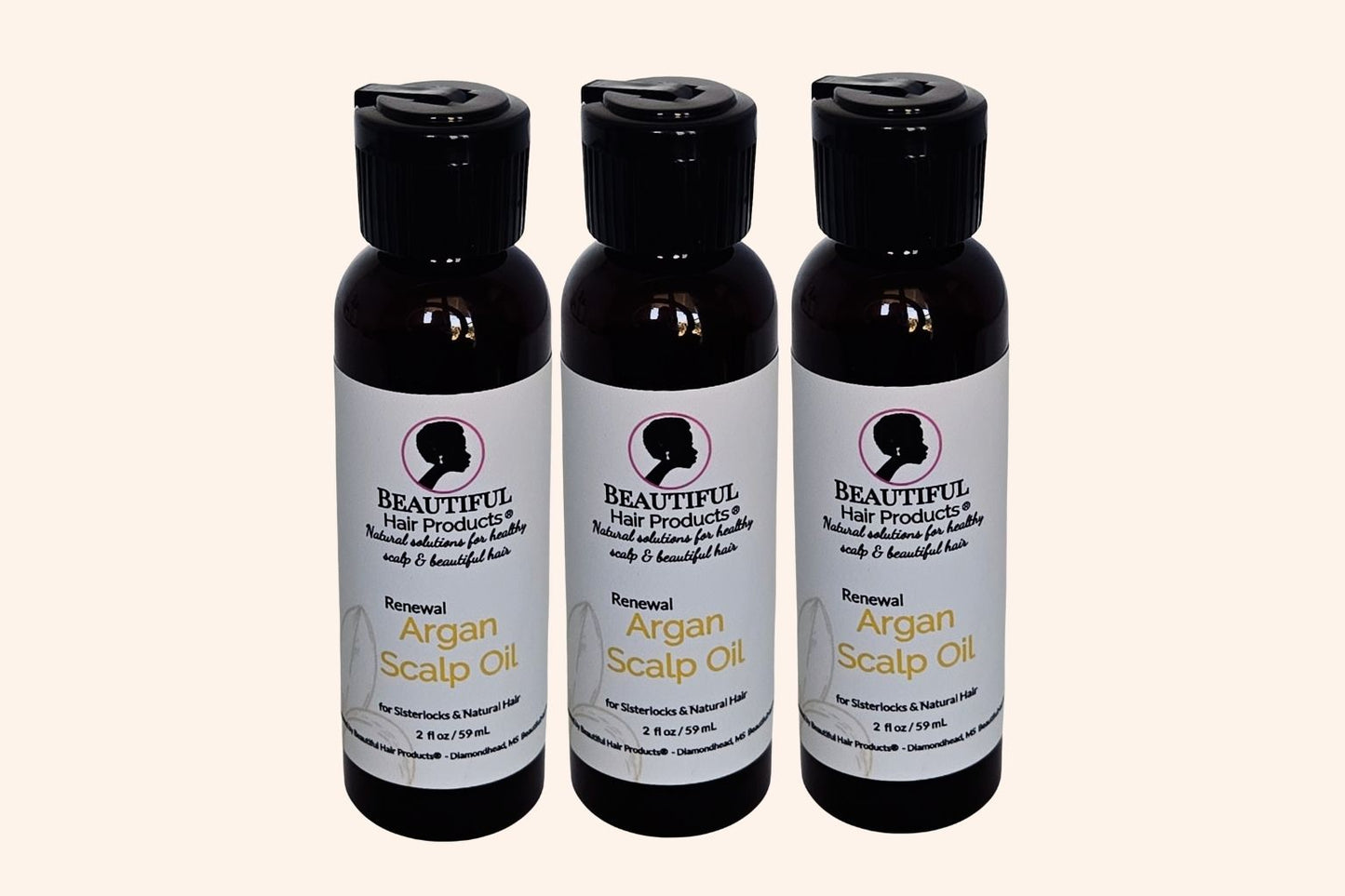 3 bottles of Argan Scalp Renewal Growth Oil 2oz bottle with gold and cream label for pure argan oil hair growth treatment