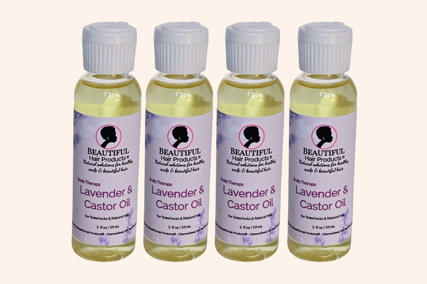 Four bottles of Lavender & Castor Scalp Therapy Oil bottle with purple and cream label for therapeutic scalp treatment
