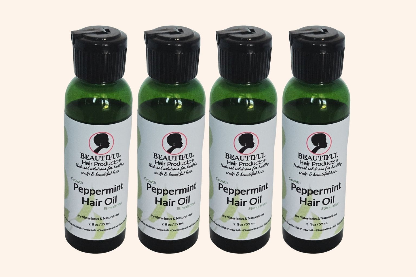 Four bottles of Peppermint Hair Growth Oil 2oz bottle with green and cream label for stimulating scalp treatment