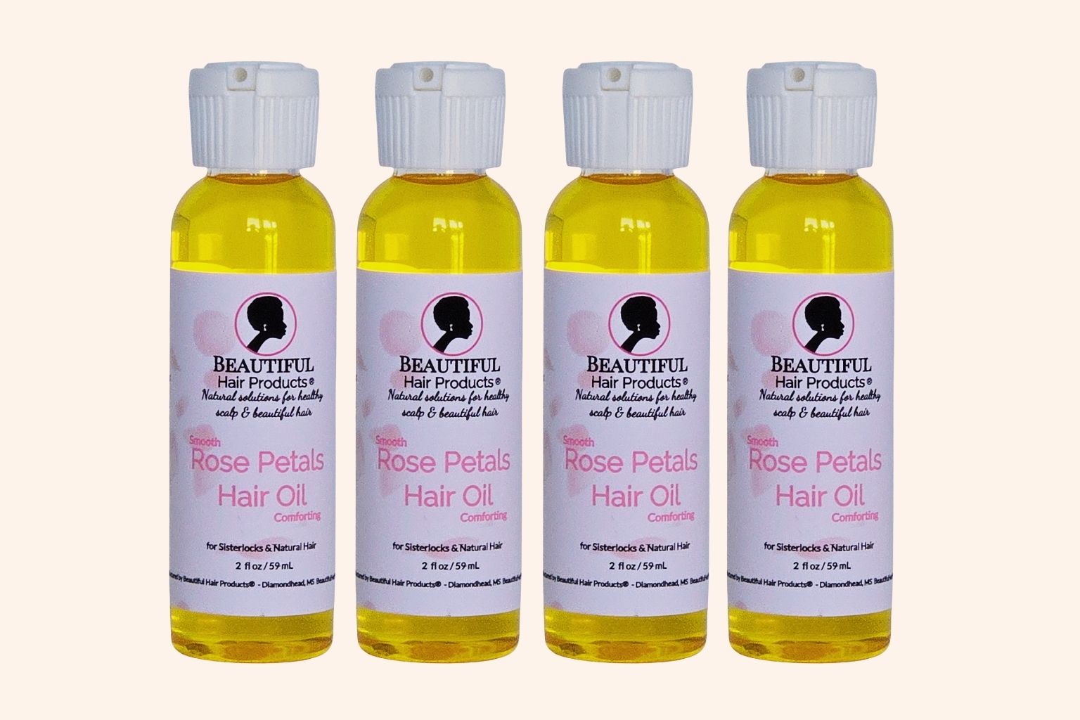 Four bottles of Rose Petals Scalp & Hair Oil bottle, 2oz with pink and cream label featuring rose petals for scalp and hair nourishment